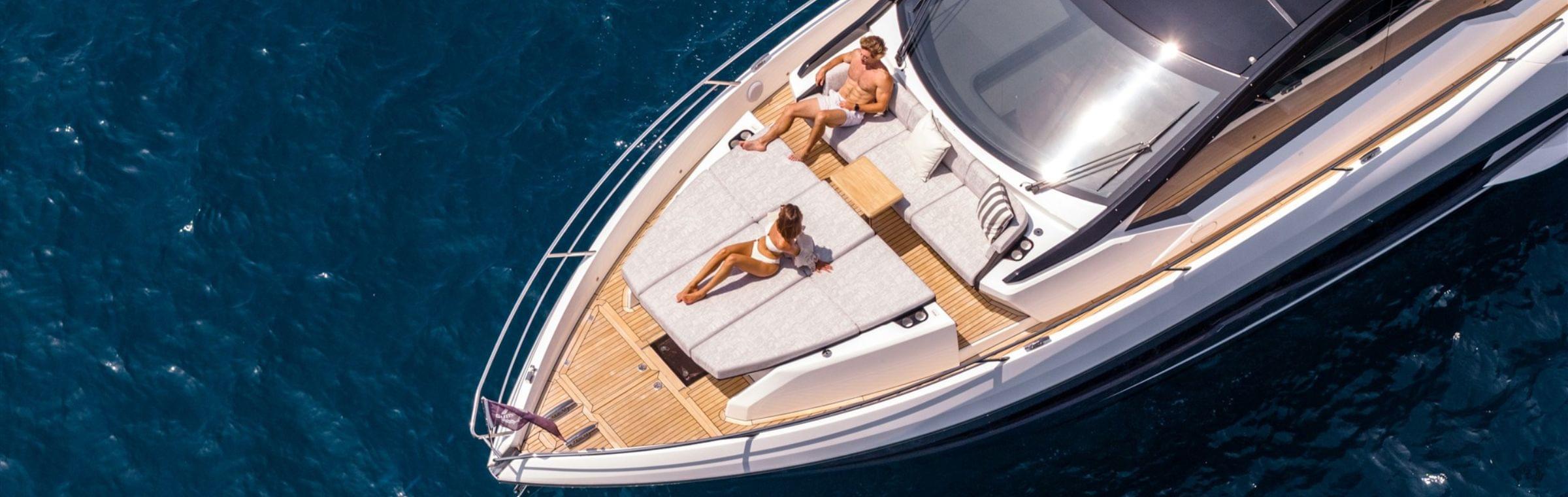 Couple relax on bow on the Sunseeker Predator 55