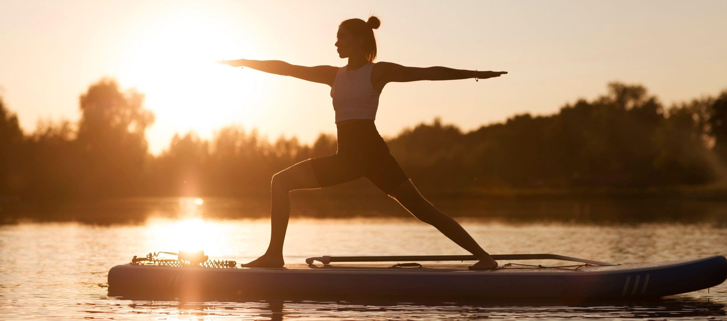 Woman doing yoga on a stand-up paddleboard Woman doing yoga on a stand-up paddleboard